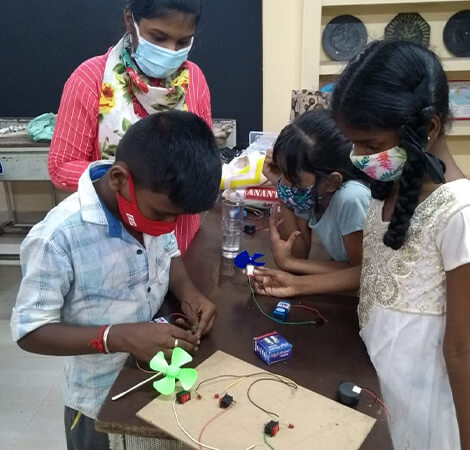 Students are practicing science, technology, and engineering lessons by operating fans with batteries