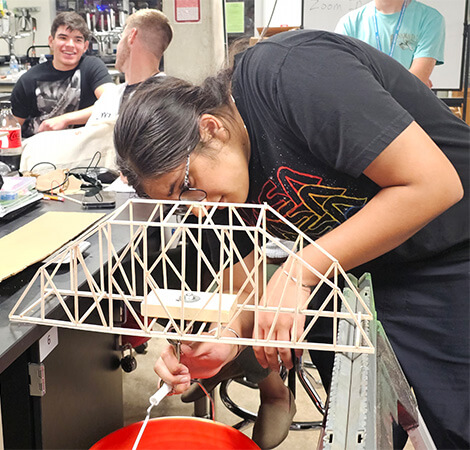 STEM student in a black T-shirt working on a science class